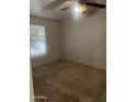 Simple carpeted bedroom with a ceiling fan and window at 9431 E Coralbell Ave # 113, Mesa, AZ 85208