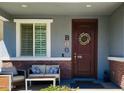 Charming front porch with seating and decorative wreath at 7064 E Osage Ave, Mesa, AZ 85212