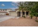 Two-story house with a beige exterior, two-car garage, and landscaping at 3259 E Isaiah Ct, Gilbert, AZ 85298