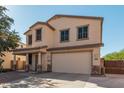 Two-story house with a beige exterior, two-car garage, and landscaping at 28614 N Sunset Dr, San Tan Valley, AZ 85143