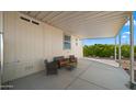 Covered patio with seating area adjacent to home at 9333 E University Dr # 45, Mesa, AZ 85207
