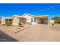 Single-wide manufactured home with covered carport and patio at 215 N Power Rd # 105B, Mesa, AZ 85205