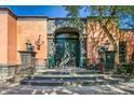 Spanish-style home with large wooden doors and lush landscaping at 8100 N 68Th St, Paradise Valley, AZ 85253
