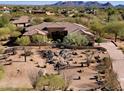 Aerial view of a house with desert landscaping and mountains at 8155 E Thorntree Dr, Scottsdale, AZ 85266