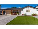 Updated single story home with artificial turf lawn at 4002 E Clarendon Ave, Phoenix, AZ 85018
