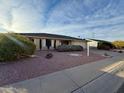 Exterior view of a house with a front yard, driveway, and for sale sign at 11067 W Oak Ridge Rd, Sun City, AZ 85351