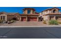 Two-story home with a red double garage door and brick driveway at 3540 N Sonoran Hls, Mesa, AZ 85207