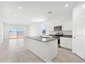 Open concept kitchen with island and stainless steel appliances at 38155 W Excussare Way, Maricopa, AZ 85138