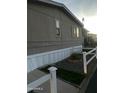 Side view of mobile home with white fence and landscaping at 4211 W Roosevelt St #79 --, Phoenix, AZ 85009