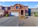 Two-story stucco home with a white garage door and landscaping at 964 W Saguaro Ln, San Tan Valley, AZ 85143