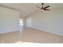 Bright living room with tile floors and ceiling fan at 8852 W Troy Dr, Arizona City, AZ 85123