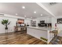 Modern kitchen featuring a large island, stainless steel appliances, and hardwood floors at 4232 W Nicolet Ave, Phoenix, AZ 85051