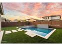 Relaxing pool and spa area with grassy backyard and modern landscaping at 19834 W Rancho Dr, Litchfield Park, AZ 85340