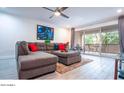 Spacious living room featuring an L-shaped sectional sofa and sliding glass doors at 7625 E Camelback Rd # A250, Scottsdale, AZ 85251