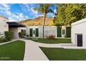 Inviting courtyard with artificial turf, seating area, and a water feature at 6432 E El Sendero Rd, Carefree, AZ 85377