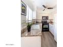 Modern kitchen with white cabinets and granite countertops at 4610 N 68Th St # 414, Scottsdale, AZ 85251