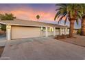 House exterior view at dusk featuring a neutral color scheme at 10452 W Meade Dr, Sun City, AZ 85351
