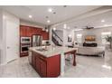 Modern kitchen with large island, stainless steel appliances, and granite countertops at 4526 E Vista Bonita Dr, Phoenix, AZ 85050