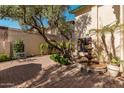 Relaxing patio with brick flooring, fountain, and lush landscaping at 2253 S El Marino --, Mesa, AZ 85202