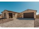 Exterior view of a single-story house with tile roof, two-car garage, and desert landscaping at 13637 W Hackamore Dr, Peoria, AZ 85383