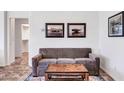 Cozy sitting area with a brown sofa and wood coffee table at 36106 N Desert Tea Dr, San Tan Valley, AZ 85140