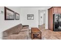Small sitting area with brown sofa and wood coffee table near kitchen at 36106 N Desert Tea Dr, San Tan Valley, AZ 85140
