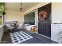 Inviting front porch with seating and stylish decor at 11133 W Cameo Dr, Sun City, AZ 85351