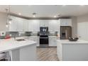 Modern kitchen with white cabinets, stainless steel appliances, and an island at 2511 W Queen Creek Rd # 205, Chandler, AZ 85248
