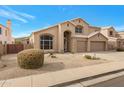 A two-story home with a two-car garage and desert landscaping in front at 14404 S 12Th St, Phoenix, AZ 85048