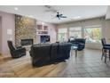 Spacious living room with a stone fireplace and leather furniture at 1841 E Gary Way, Phoenix, AZ 85042