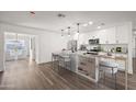 Modern kitchen with island, white cabinets, and granite countertops at 1173 E Cordova Ave, Casa Grande, AZ 85122