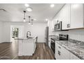Updated kitchen with white cabinets, granite counters, and island at 1173 E Cordova Ave, Casa Grande, AZ 85122