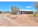 Front yard view of the house, showing a covered porch and desert landscaping at 30240 N 60Th St, Cave Creek, AZ 85331