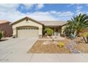 One-story house with desert landscaping, two-car garage, and neutral color scheme at 17826 N Encanto Dr, Surprise, AZ 85374