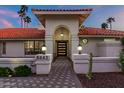Front entry with arched entryway, tile flooring, and modern door at 8643 E San Jacinto Dr, Scottsdale, AZ 85258