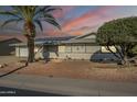 Single story home with solar panels and desert landscaping at 12442 W Marble Dr, Sun City West, AZ 85375