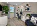 Bright home office with built-in shelving and granite countertops at 36433 W San Ildefanso Ave, Maricopa, AZ 85138