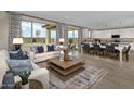 Open living and dining area with large windows and stylish furnishings at 36433 W San Ildefanso Ave, Maricopa, AZ 85138