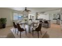 Bright dining area with a concrete table and modern chairs at 20017 N Ponderosa Cir, Sun City, AZ 85373