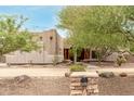 Exterior view of a Southwestern style home with stucco walls and a courtyard entry at 11305 S 195Th Dr, Buckeye, AZ 85326