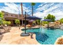 Resort-style pool with patio furniture and palm trees in the background at 11305 S 195Th Dr, Buckeye, AZ 85326