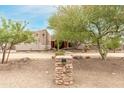 Exterior view of a Southwestern style home with stucco walls and a courtyard entry at 11305 S 195Th Dr, Buckeye, AZ 85326