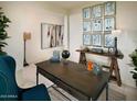 Bright home office with a large desk, wall art, and comfortable chair at 20640 N Confetti Ct, Maricopa, AZ 85138