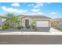Single-story home with landscaped yard and two-car garage at 17917 W Amberwood Dr, Goodyear, AZ 85338