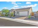 Tan house with desert landscaping and a two-car garage at 17917 W Amberwood Dr, Goodyear, AZ 85338