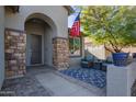 Inviting entryway with stone pillars, comfortable seating, and a patterned rug at 23852 N 167Th Ln, Surprise, AZ 85387