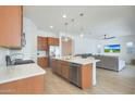 Open kitchen with island and stainless steel appliances at 17917 W Amberwood Dr, Goodyear, AZ 85338