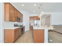 Open kitchen with island and stainless steel appliances at 17917 W Amberwood Dr, Goodyear, AZ 85338