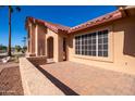 Well maintained home with a large window and brick facade at 15332 W Huron Dr, Sun City West, AZ 85375