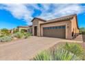 Single-story home with a two-car garage and landscaped front yard at 3985 N Daisy Dr, Florence, AZ 85132